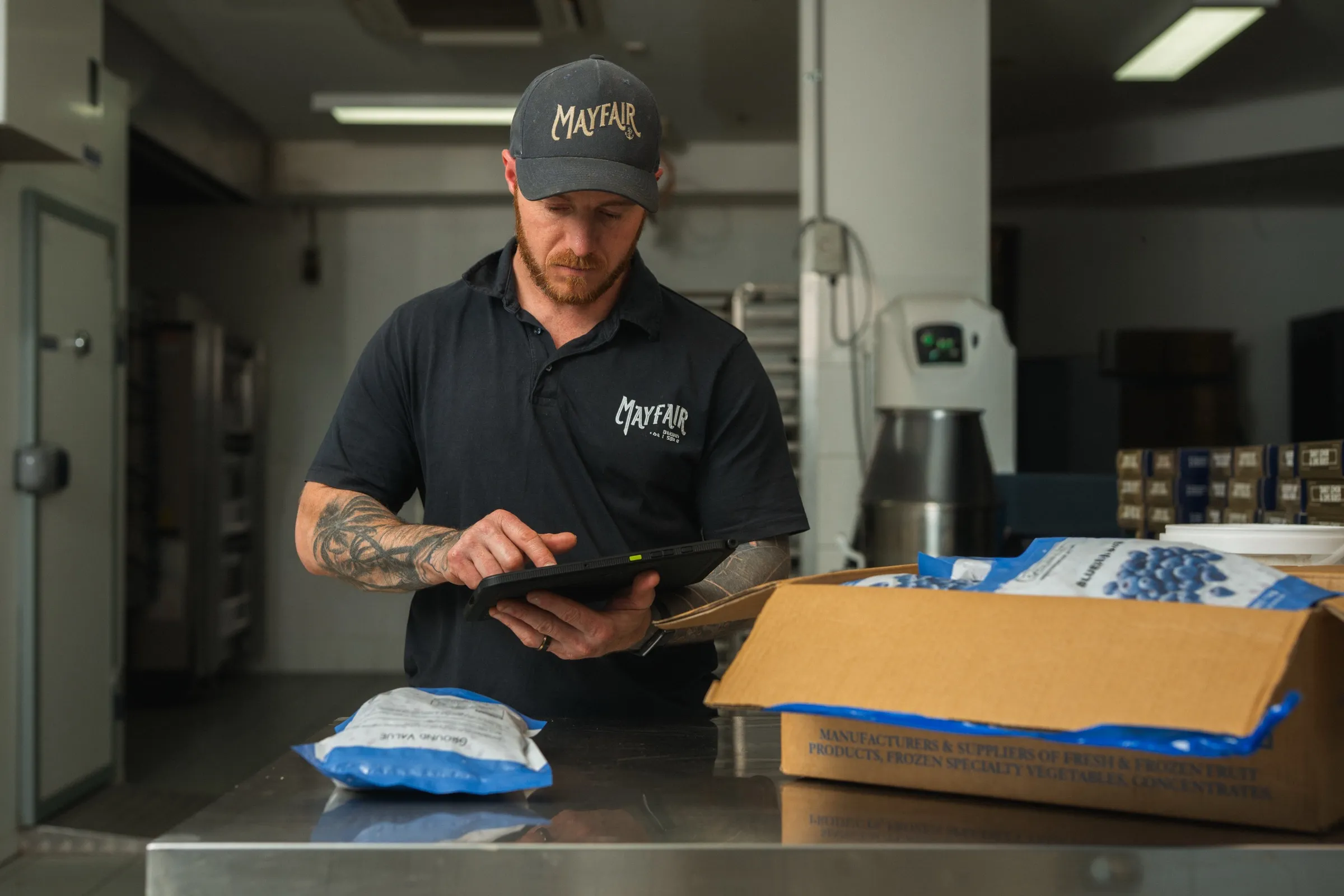 A Mayfair Bakery team member checking a delivery on the Klara tablet